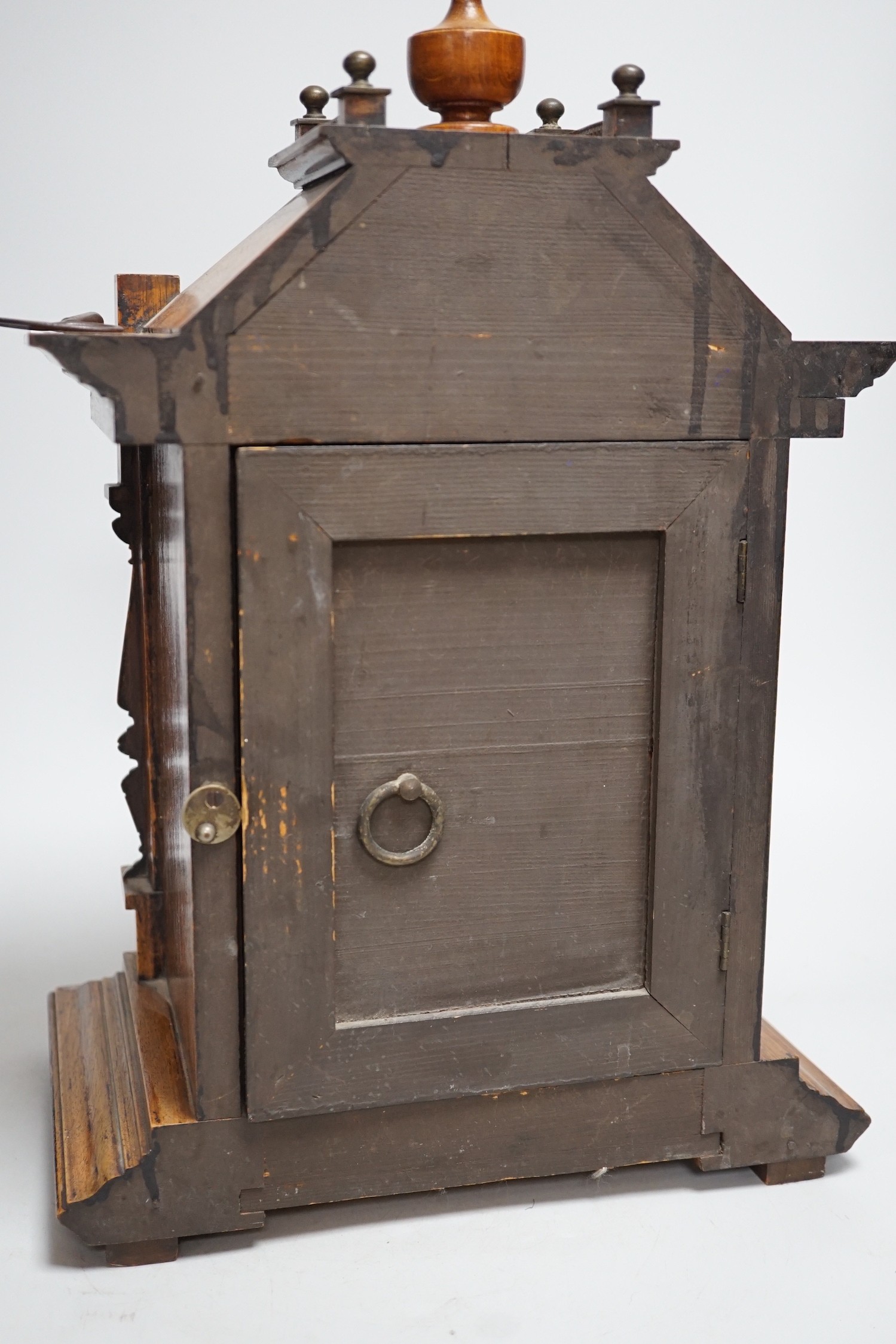 A German oak cased clock, plaque reads ‘Presented to Harry Collins on the occasion of his marriage by the members of Bradford House May 1st 1897’. Height 40cm
